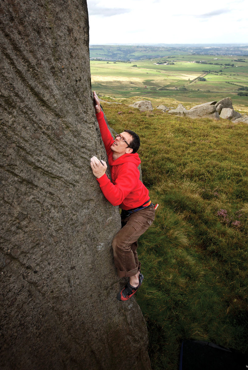 Rick Legge teeters up the striking line that is the arête of Archery (V6) in The Two Arches Boulders area at the far right of West Nab. Photo: © David Simmonite