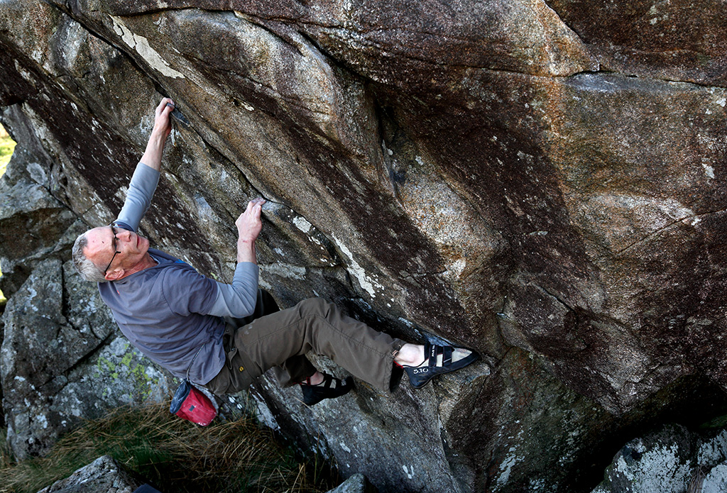 The Traverse of the Mushroom Boulder is a stamina test usually climbed right to left at V3. However here Tim Carruthers climbs it in the opposite direction making it a touch harder. It's fantastic either way. Photo: © David Simmonite