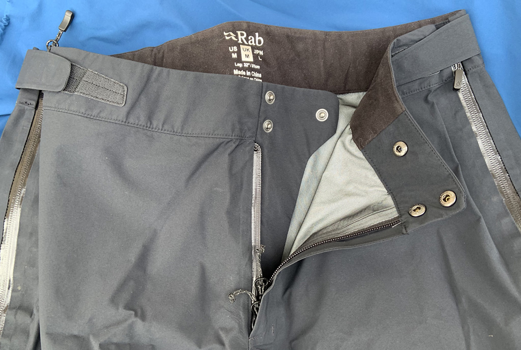 The side Velcro tabs and waist fastening.